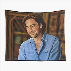 Javier Bardem painting a tapestry.