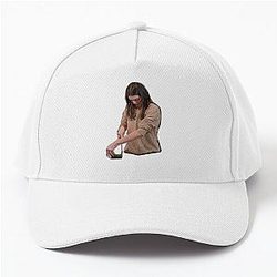 Kendall Jenner cutting a cucumber in a Baseball Cap