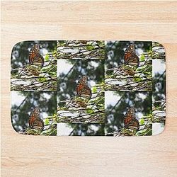 Monarch butterfly before flying in search of sun by Yannis Lobaina bath mat