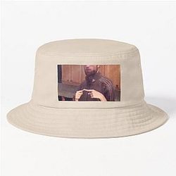 Robert Pattinson in a brown suit and a bucket hat