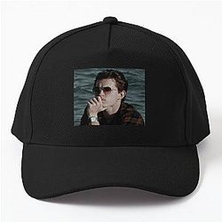 Tom Holland relaxing on the beach with a Baseball Cap
